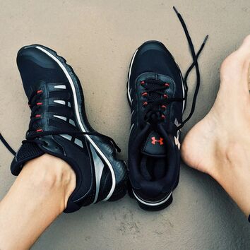 Fußgesundheit ein Fuß im Sportschuh, der andere Fuß nackt neben Sportschuh